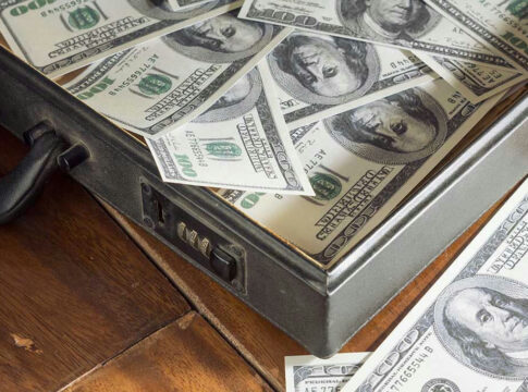 Open briefcase filled with one-hundred-dollar bills.