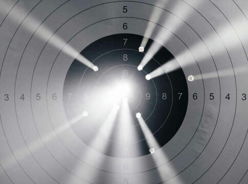 Target with multiple bullet holes and light rays.