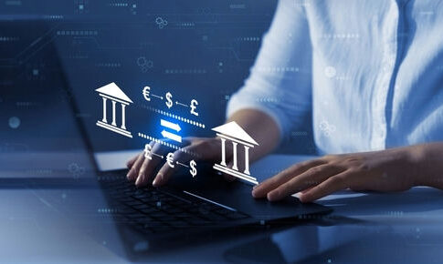 Person typing, banking and currency exchange symbols displayed.